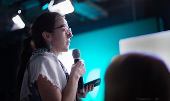 a woman speaks into a handhelp microphone