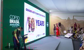 Bridet Burns sits at a microphone