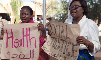 a group of people looking towards crowd at a panel