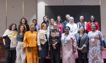 a team of women stand for a group photo