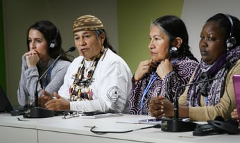 a group of people looking towards crowd at a panel